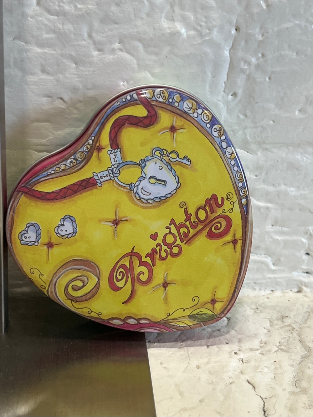 Brighton Yellow Heart Tin with Red Script and Decorative Accents